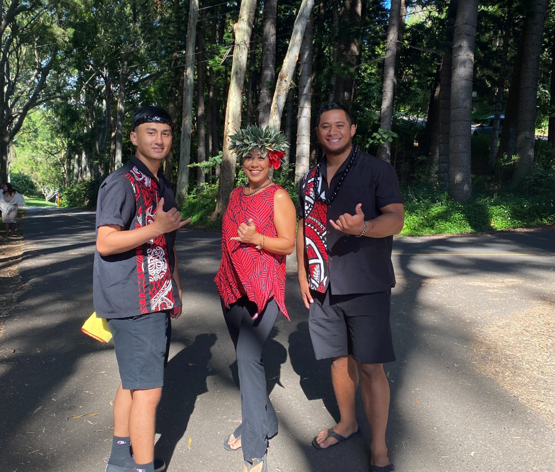 luau experience in hawaii three of the wonderful tour guides at the experience nutridge luau event are dressed in black and red hawaiian attire on tantalus, oahu