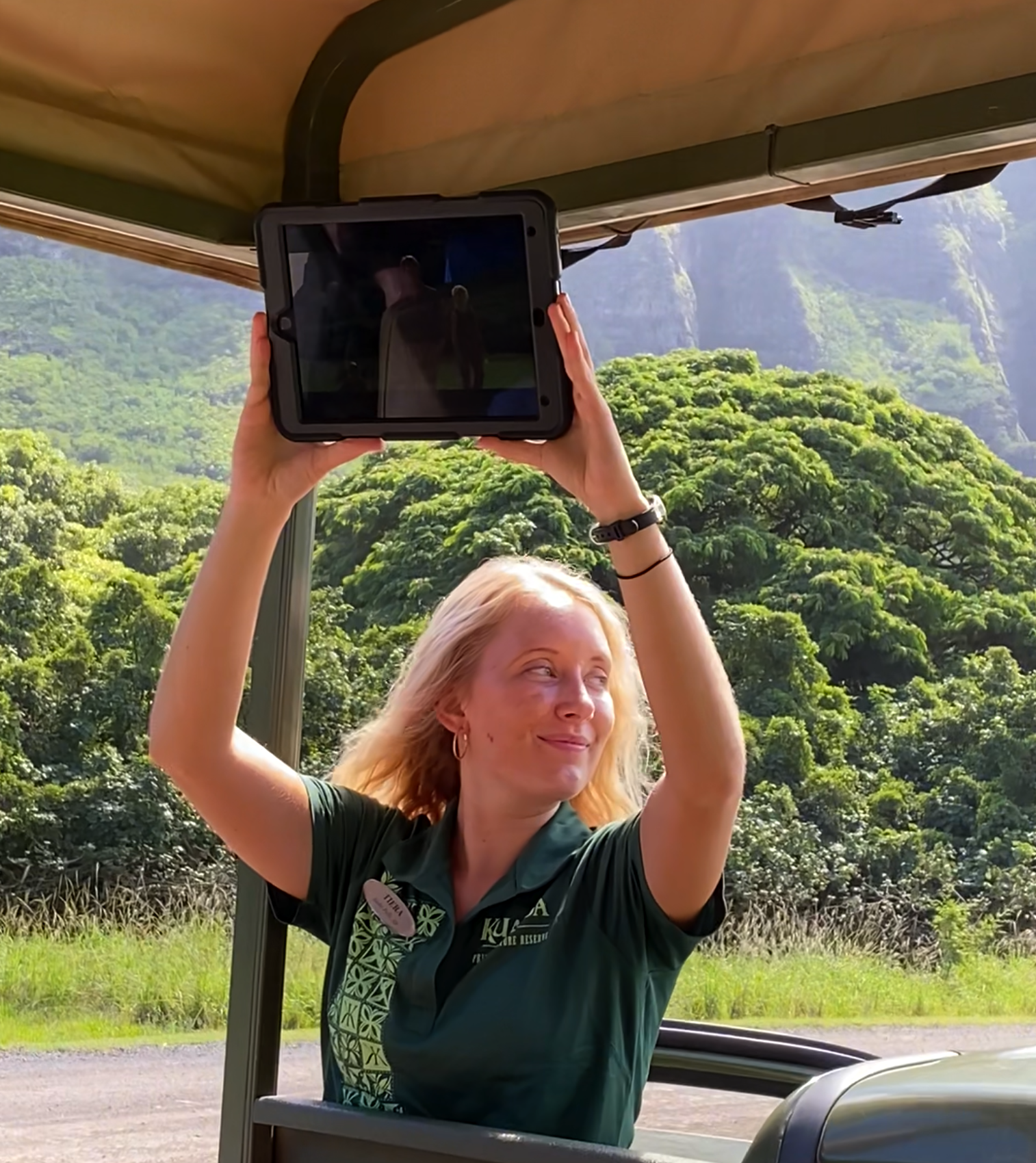 jurassic-park-tour-guide jurassic park tour guide holds up an ipad so visitors can watch a scene from the movie